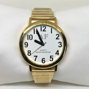 Quartz analog gold tone watch 41mm round dial black indices size 7” running